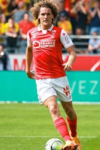 Wout Faes playing for Reims