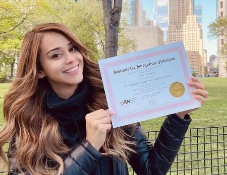 Yanet Garcia Showing The Cerficate Of Health Coach